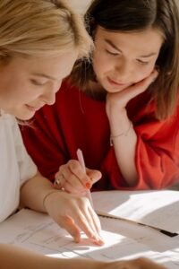 Maths tutor helping a student with schoolwork during a one-on-one tutoring session
